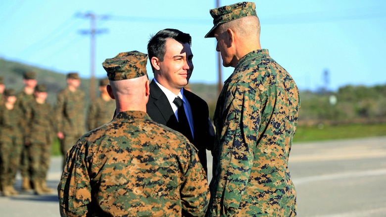 Sgt. Zachary L. Piepenhagen (center), is congratulated by Maj. Gen. David Coffman, deputy commanding general, I Marine Expeditionary Force, after being awarded the Navy and Marine Corps Medal, at Marine Corps Base Camp Pendleton, California, Jan. 26, 2017. Piepenhagen was awarded the medal for saving the life of a distressed Sailor who climbed over the guard rail in an attempt to commit suicide while serving with the 13th Marine Expeditionary Unit. 