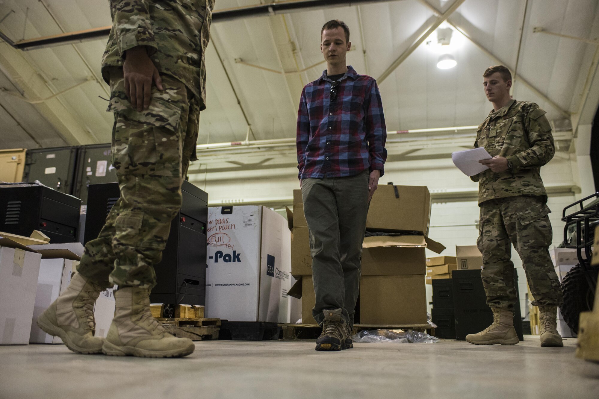 A participant, middle, attempts to walk a straight line during Standardized Field Sobriety Test training for 27th Special Operations Security Forces Squadron members Jan. 25, 2017, at Cannon Air Force Base, N.M. The officers had the volunteers perform as series of tasks testing motor skills like balancing on one foot and walking in a straight line while simultaneously assessing their mental sharpness with concise counting and answering of questions. (U.S. Air Force photo by Senior Airman Luke Kitterman/Released)    