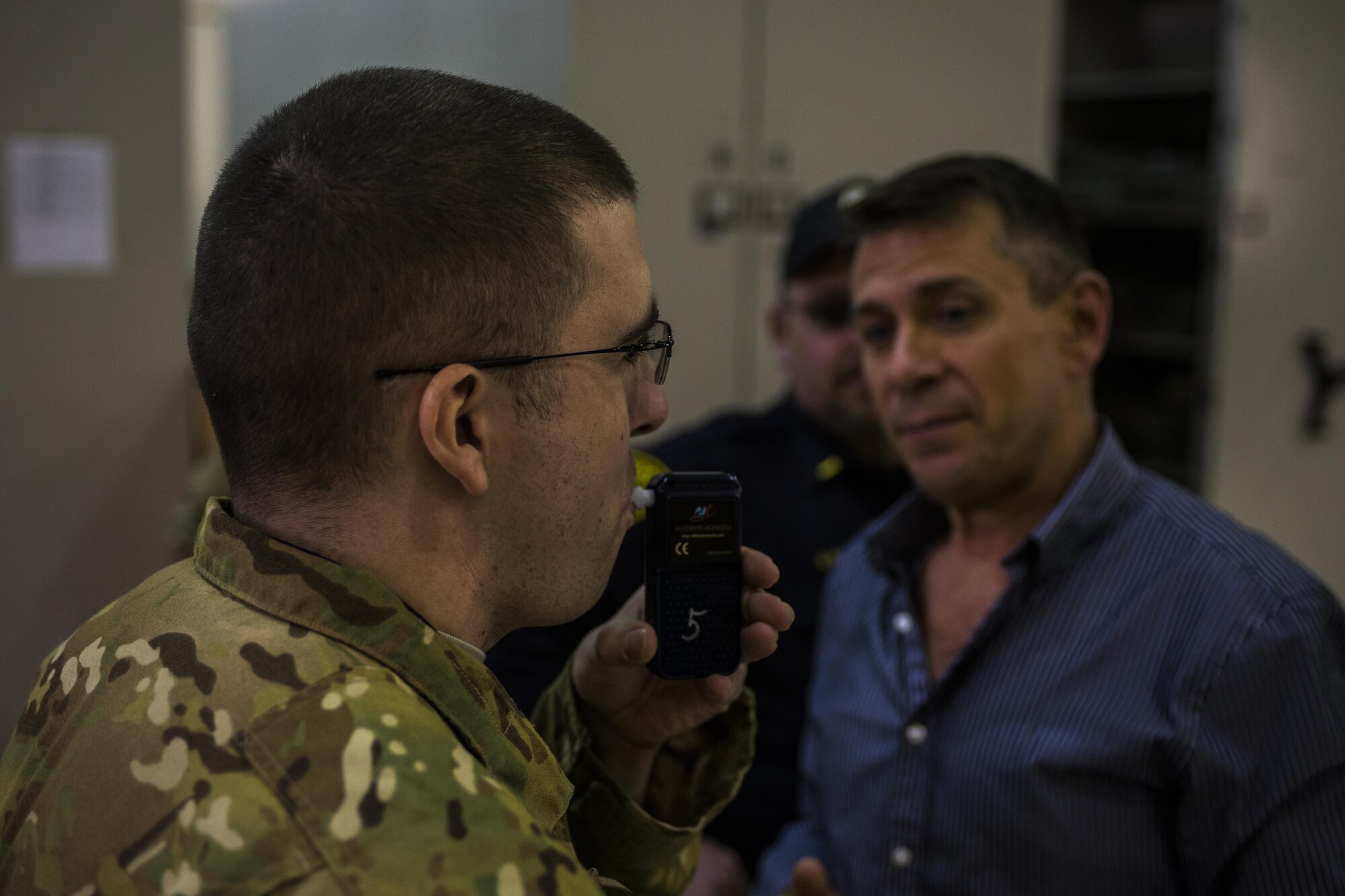 Gary Rhode, 27th Special Operations Security Forces Squadron training superintendent, right, watches as a participant conducts a breathalyzing test during Standardized Field Sobriety Test training for 27th SOSFS members Jan. 25, 2017, at Cannon Air Force Base, N.M. Rhode led twelve Security Forces members in his National Highway Traffic Safety Administration 24-hour class on SFSTs. (U.S. Air Force photo by Senior Airman Luke Kitterman/Released)    