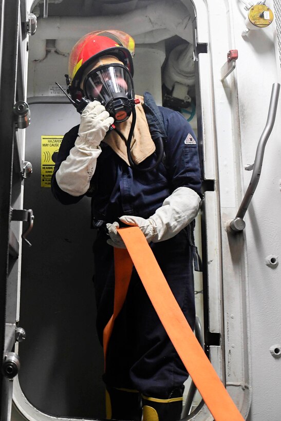 Navy Petty Officer 3rd Class Bruce Greenecairnduff communicates with members of the fire team during a fire drill aboard Arleigh Burke-class guided-missile destroyer USS Wayne E. Meyer in the Pacific Ocean, Jan. 25, 2017. Greenecairnduff is a damage controlman. Navy photo by Petty Officer 3rd Class Kelsey L. Adams