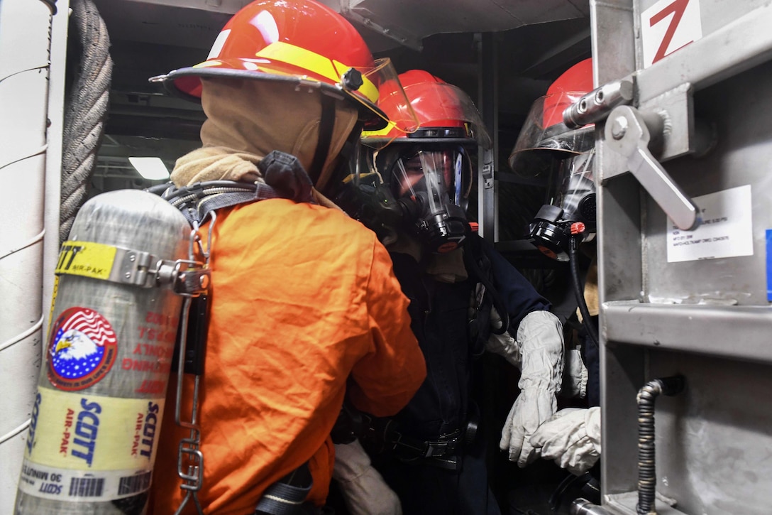 Sailors simulate evacuating a team member suffering from smoke inhalation during a fire drill aboard Arleigh Burke-class guided-missile destroyer USS Wayne E. Meyer in the Pacific Ocean, Jan. 25, 2017. Navy photo by Petty Officer 3rd Class Kelsey L. Adams