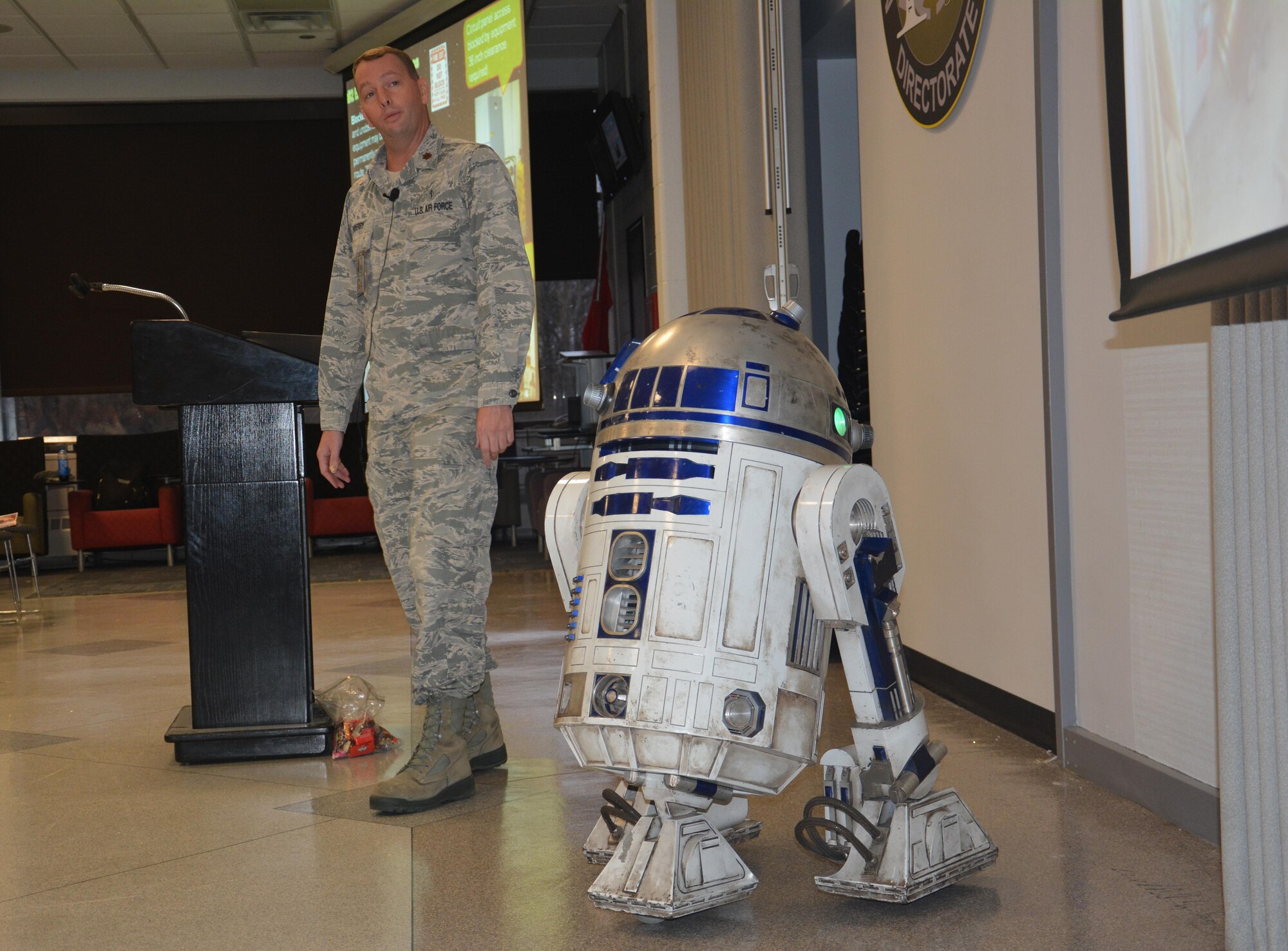 Maj. James Enderby, joined by R2-D2, served as emcee and coordinator for the Materials and Manufacturing Directorate’s Star Wars-themed Safety Down Day.  The annual event encourages personnel to observe and refresh themselves on proper safety protocol.  (U.S. Air Force photo/David Dixon)