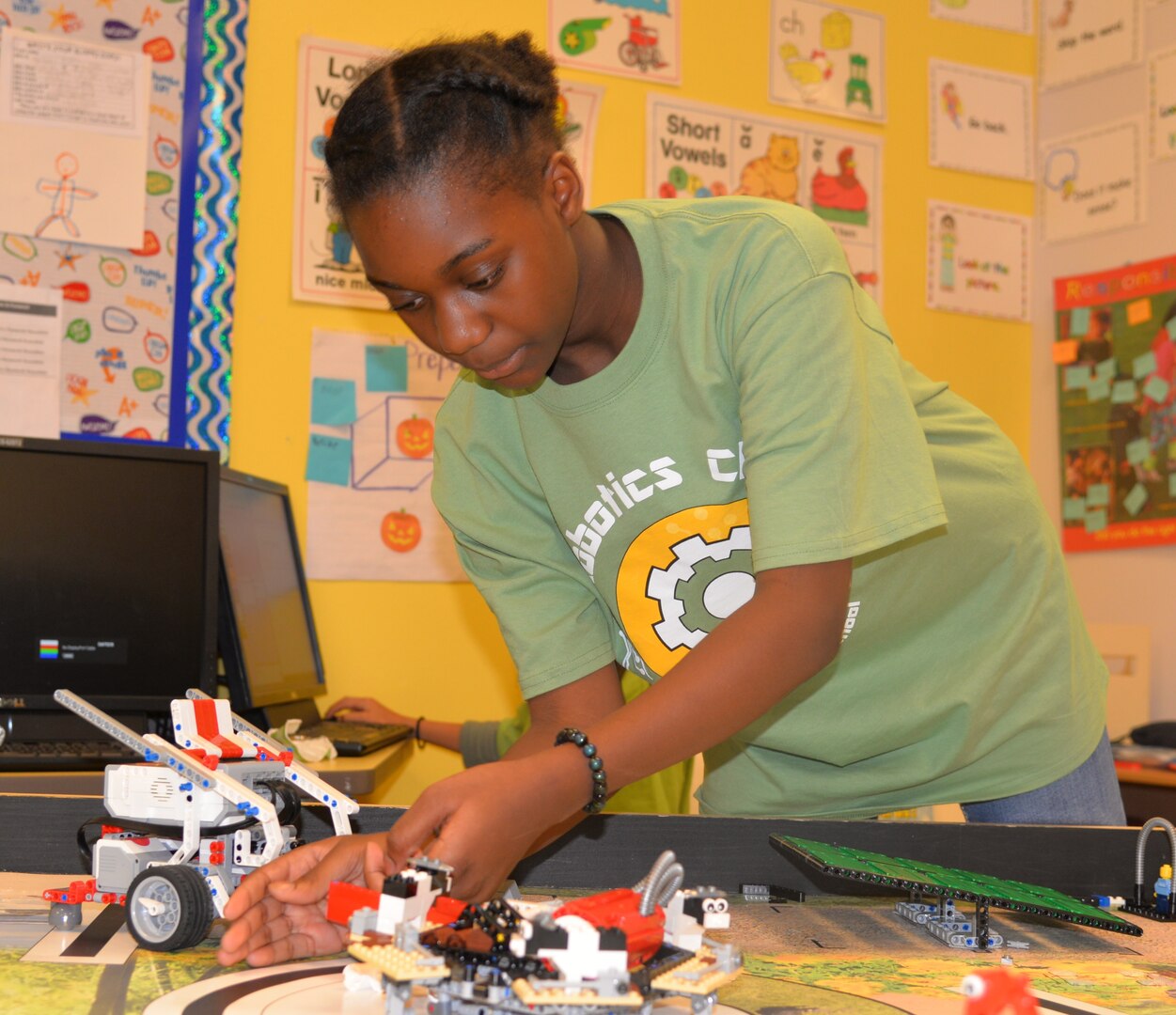 Caelyn Maddox, 10, a member of the  Fort Sam Houston Elementary School Robotics Club at Joint Base San Antonio-Fort Sam Houston, prepares her robot for competition.