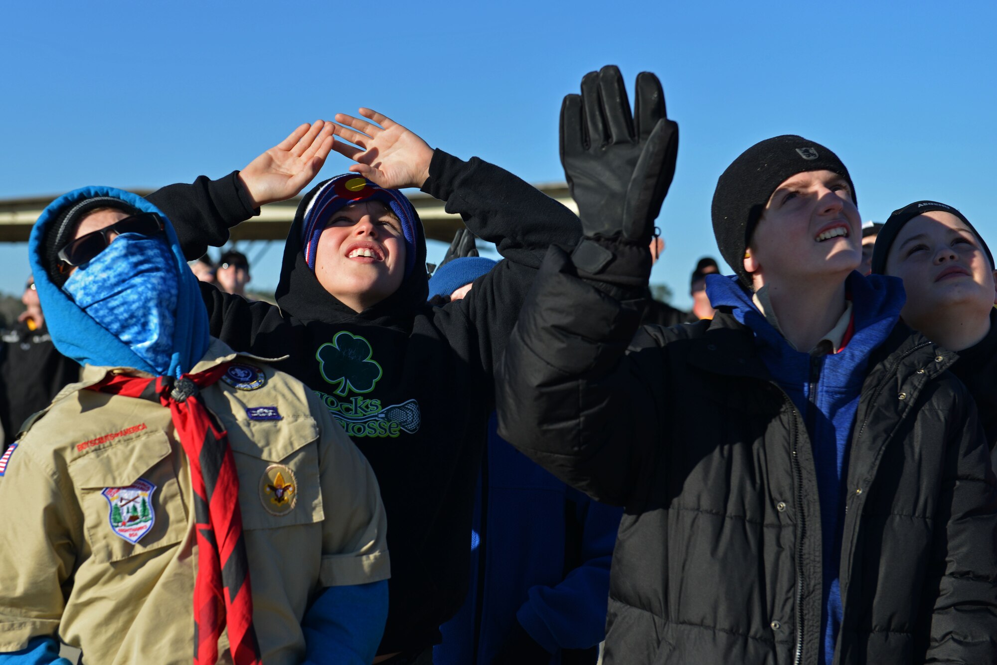 Boy Scout Troop 232 members shield their eyes from the sun as Air Combat Command’s F-16 Viper Demonstration Team performs at Shaw Air Force Base, S.C., Jan. 27, 2017. Not only did the troop get to watch the demonstration, they also asked questions and learned about pilot gear, F-16CM Fighting Falcons and the Air Force. (U.S. Air Force photo by Airman 1st Class Destinee Sweeney)