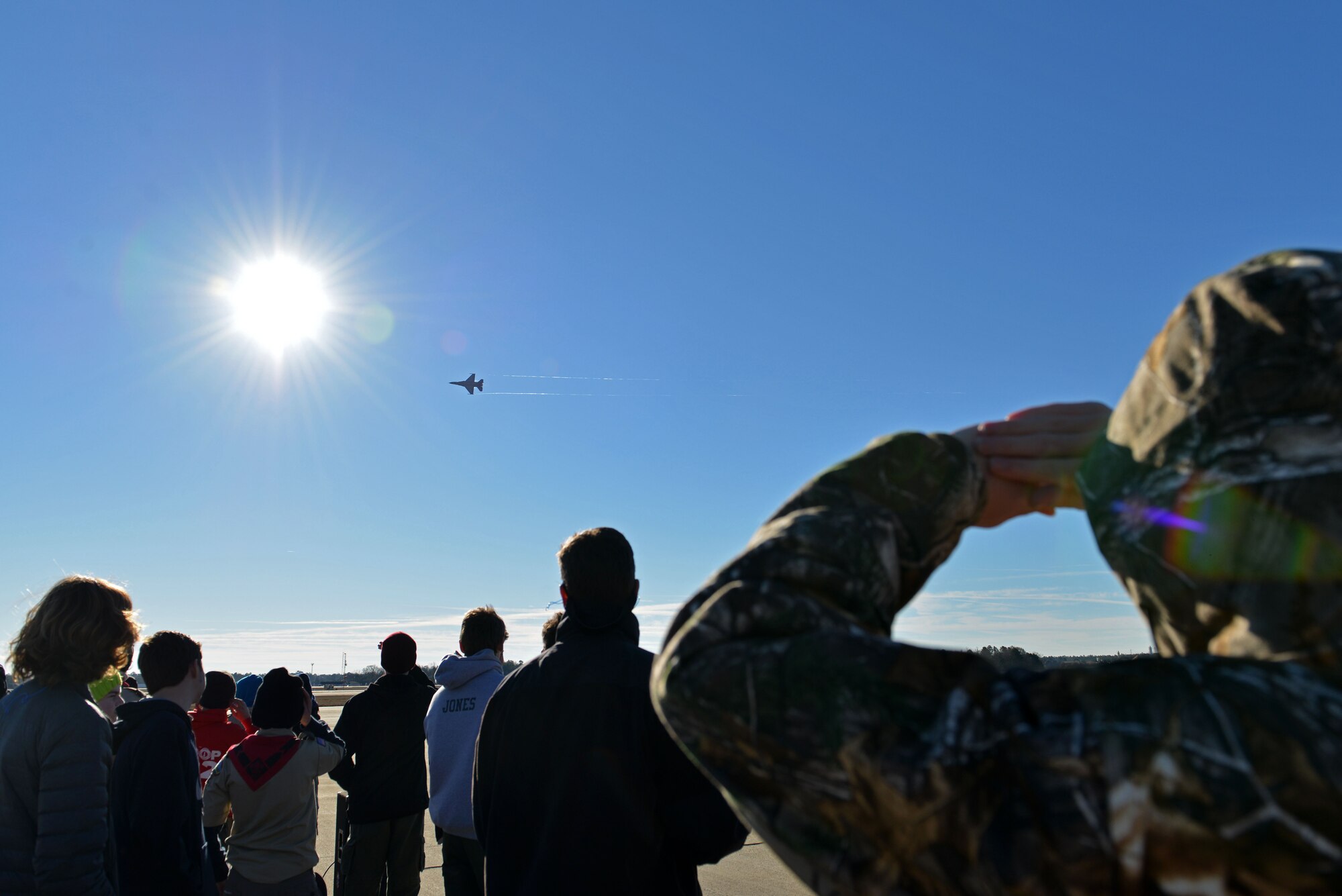 Boy Scout Troop 232 members watch U.S. Air Force Maj. Craig Baker, Air Combat Command’s F-16 Viper Demonstration Team pilot, perform during his last flight at Shaw Air Force Base, S.C., Jan. 27, 2017. During his time as a demo pilot Baker performed in approximately 40 air shows in the United States and Canada, demonstrating U.S. Air Force airpower and professionalism. (U.S. Air Force photo by Airman 1st Class Destinee Sweeney)