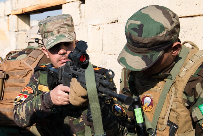 Iraqi army Lt. Hager Haider, Iraqi Ranger instructor, coaches an Iraqi Ranger trainee Jan. 23, Camp Taji, Iraq. This training is part of the overall Combined Joint Task Force – Operation Inherent Resolve, building partner capacity mission to increase the effectiveness of Iraqi forces fighting ISIL.