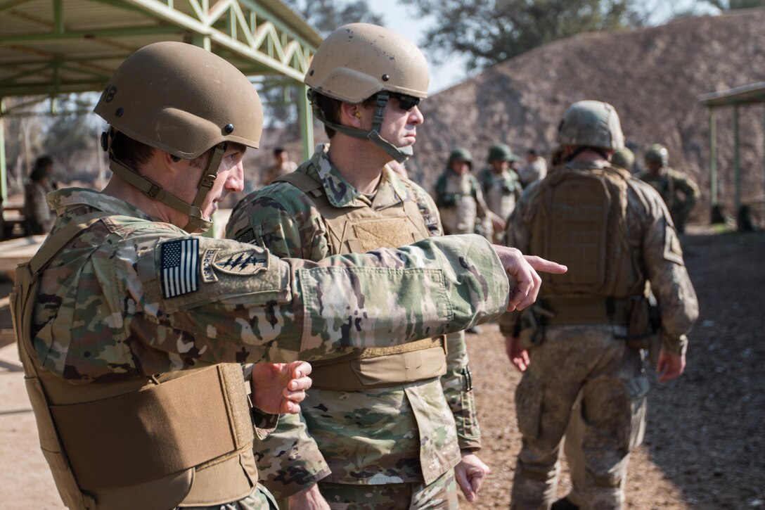 U.S. Army Sgt. 1st Class Carson Headley, and U.S. Army Sgt. 1st Class Russell Shields, Office of Security Cooperation Iraq senior-enlisted advisors, Security Sector Reform Group, discuss their observations of Nineva Police weapons training Jan. 24, 2017, Camp Taji, Iraq. Combined Joint Task Force – Operation Inherent Resolve, aims to enable and equip local forces to defeat ISIL in Iraq.  (U.S. Army photo by Spc. Derrik Tribbey)