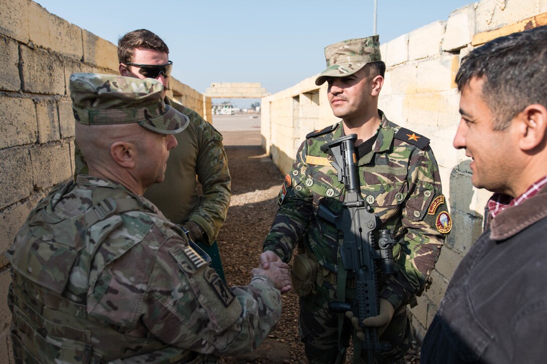 Command Sgt. Maj. Benjamin Jones, senior-enlisted leader, Combined Joint Task Force – Operation Inherent Resolve, discusses training with Iraqi army Lt. Hager Haider, Iraqi Ranger instructor, Jan. 23, 2017, Camp Taji, Iraq. Training at building partner capacity sites is an integral part of Combined Joint Task Force – Operation Inherent Resolve’s global Coalition effort to train Iraqi security forces personnel to defeat ISIL.  (U.S. Army photo by Spc. Derrik Tribbey)
