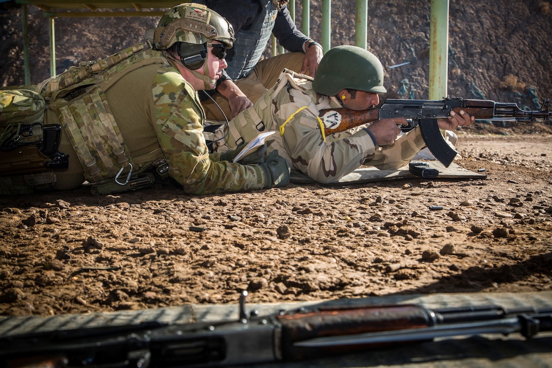 An Australian army trainer coaches an Iraqi Ninevah police officer in marksmanship fundamentals during training at Camp Taji, Iraq, Jan. 28, 2015. The police group and zero their rifles for the first time during a six-week training course led by Coalition forces in support of Combined Joint Task Force – Operation Inherent Resolve, the global Coalition to defeat ISIL in Iraq and Syria.  (U.S. Army photo by Spc. Christopher Brecht)