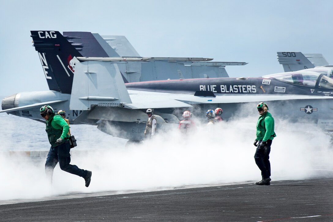 Sailors conduct flight operations on the flight deck of the aircraft carrier USS Carl Vinson in the Pacific Ocean, Jan. 26, 2017. The Carl Vinson Carrier Strike Group is on a regularly scheduled Western Pacific deployment as part of the U.S. Pacific Fleet-led initiative to extend the command and control functions of U.S. 3rd fleet. Navy Photo by Seaman Jake Cannady