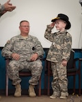 Honorary enlistee Rowan Windham renders a salute after being presented with his own Cavalry Stetson. Windham was honorarily enlisted into the Texas Army National Guard at a ceremony held at Camp Mabry in Austin, Texas, March 27, 2015. During one of his stays at the Children's Hospital in San Antonio, Rowan met Sgt. David Hixson, a medic with the Texas Army National Guard. There, Rowan shared his dream of always wanting to be a Soldier and soon after, Hixson, with the help of fellow Texas National Guard members, made it all possible. 