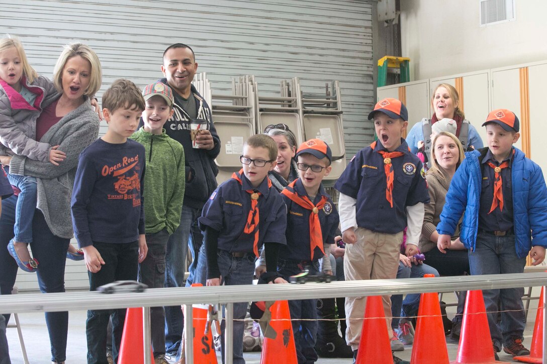 Children with Cub Scout Pack 78 cheer as their race cars pass the finish line during the annual Cub Scout Pinewood Derby at the Armed Services YMCA Scout Hut, Jan. 21, 2017. (U.S. Marine Corps photo by Cpl. Thomas Mudd)