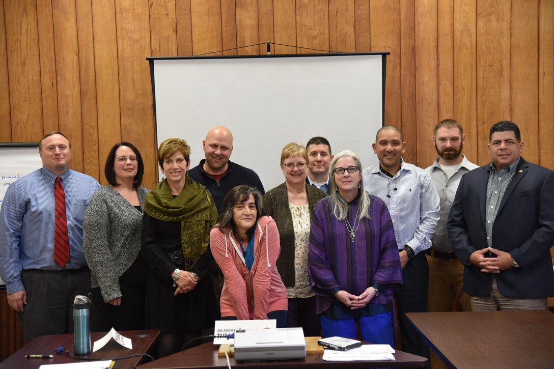 Catholic Charities staff poses with U.S. Army Reserve instructors and facilitators during a planning assistance visit to Catholic Charities of Oneida/Madison County, January 23 through the 27th. (Left to Right) Mr. Robert Stabb, Emergency Management Specialist at U.S. Army Reserve Command; Ms. Jill Roberts, FCSS Program Coordinator; Mrs. Denise Cavanaugh, Executive Director of Catholic Charities of Oneida/Madison County; Mr. Jim Smith, Property Manager; Ms. Connie Marcus, Program Manager; Capt. Robert Luzarraga; Master Sgt. Hector Perez; Mr. Tyler Bourgeois, Director of Special Projects; Mr. Carlos Alvarado, Safety and Occupational Health Specialist for the 1st Mission Support Command and Professional Continuity Practitioner Level 1 (FEMA); (Front) Ms. Ann Marie Story, Director of Quality Improvement; Mrs. Jan Stasaitis, Director of Administration.