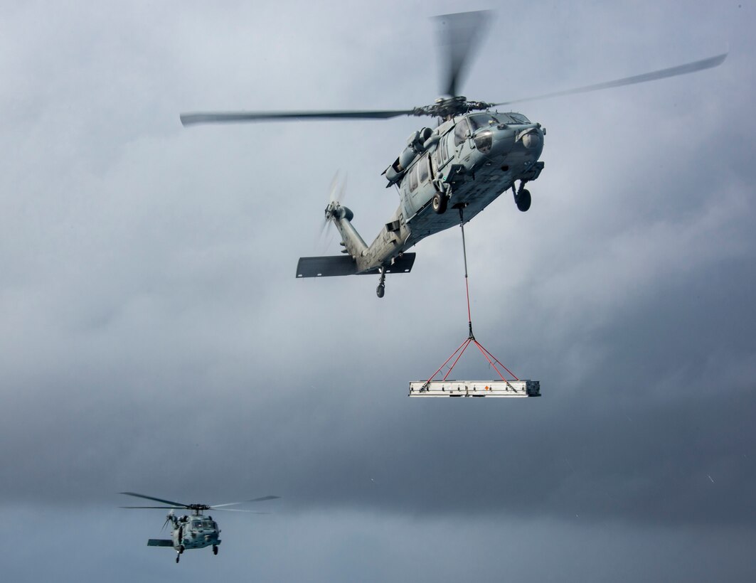 Two MH-60S Seahawk helicopters participate in a vertical replenishment with the Military Sealift Command dry cargo and ammunition ship USNS Charles Drew to the aircraft carrier USS Carl Vinson in the Pacific Ocean, Jan. 28, 2017. Navy photo by Petty Officer 2nd Class Sean M. Castellano