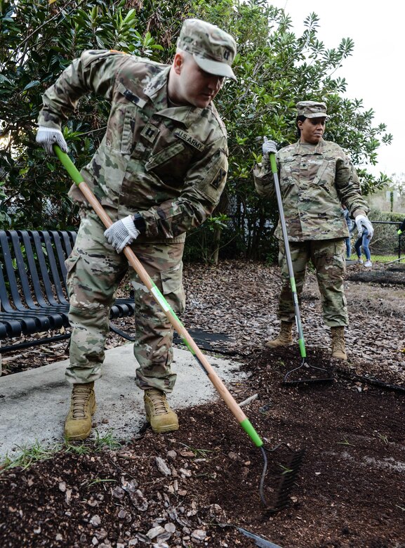 Army Capt. Josh C. Agnew (left), a Chippewa Falls, Wisc., native serving operations officer, 143d ESC, rakes mulch and soil in preparation for the installation of a new garden bed at the Colonialtown North Community Garden Jan. 27, 2017, in Orlando, Fla. Agnew and six other Army Reserve Soldiers joined scores of volunteers from the Orlando community to help bring the garden back to its former, greener glory. Directed by Green Works Orlando in conjunction with the NFL’s Environmental Program, the garden’s revival was one of the many community projects both organizations managed to lighten the environmental footprint produced by the tens of thousands of football fans who have flocked to The City Beautiful to watch the NFL’s first Pro Bowl game to take place in the Continental U.S. since 1979. 