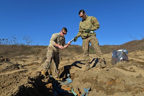 U.S. Air Force Staff Sgt. Andrew Wright, 20th Civil Engineer Squadron explosive ordnance disposal equipment section chief, left, and Senior Airman Tyler McMillan Wammack, 20th CES EOD journeyman, right, lay down C-4 explosives on top of bomb dummy unit (BDU) 33s at Poinsett Electronic Combat Range, Wedgefield, S.C., Jan. 25, 2017. The EOD Airmen used approximately 75 pounds of C-4 to destroy BDU munitions, which are training munitions used by 20th Fighter Wing pilots to maintain readiness. (U.S. Air Force photo by Airman 1st Class Destinee Sweeney)