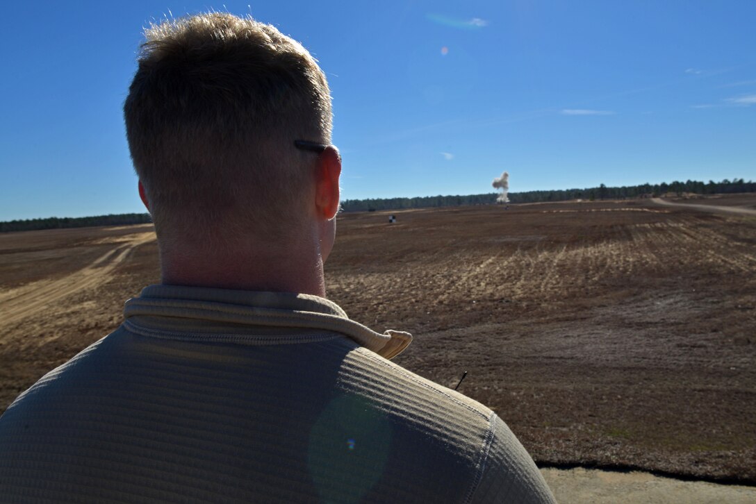 U.S. Air Force Airman 1st Class Tyler Kochlany, 20th Civil Engineer Squadron explosive ordnance disposal apprentice, watches a detonation at Poinsett Electronic Combat Range, Wedgefield, S.C., Jan. 25, 2017. The detonation was the first of two during the EOD flight’s semiannual cleanup of bomb dummy units at Poinsett. (U.S. Air Force photo by Airman 1st Class Destinee Sweeney)
