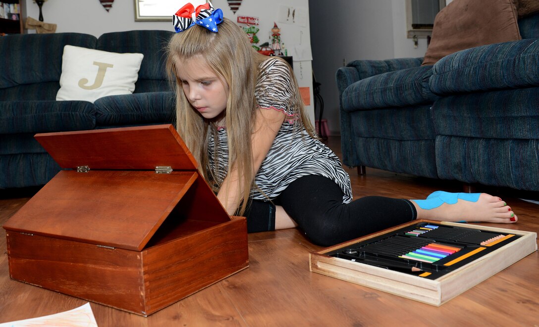 Eveylynn Johns, age nine, daughter of U.S. Army Sgt. Matthew Johns, 221st Military Police Detachment military police officer, draws with an art set in her home at Joint Base Langley-Eustis, Va., Jan. 5, 2017.  Eveylynn has been diagnosed with a genetic disorder called Ehlers-Danlos Syndrome, as well as postural orthostatic tachycardia syndrome. (U.S. Air Force photo by Staff Sgt. Teresa J. Cleveland)