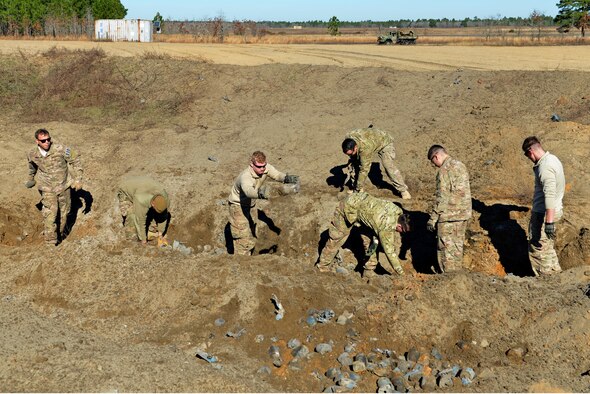 U.S. Airmen assigned to the 20th Civil Engineer Squadron explosive ordnance disposal flight work together to sort through leftover bomb dummy units (BDUs) at Poinsett Electronic Combat Range, Wedgefield, S.C., Jan. 25, 2017. After the first detonation, EOD Airmen must ensure any remaining intact BDUs are destroyed in a second clean-up detonation. (U.S. Air Force photo by Airman 1st Class Destinee Sweeney)