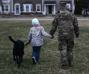 U.S. Army Sgt. Matthew Johns, 221st Military Police Detachment military police officer, and his daughter AudreeAna, age six, walk her service dog, Hope, at Joint Base Langley-Eustis, Va., Jan. 5, 2017. Before arriving to JBLE due to a permanent change of station, the Johns family worked with the Exceptional Family Member Program, a mandatory program for all active-duty service members with special needs family members. (U.S. Air Force photo by Staff Sgt. Teresa J. Cleveland)