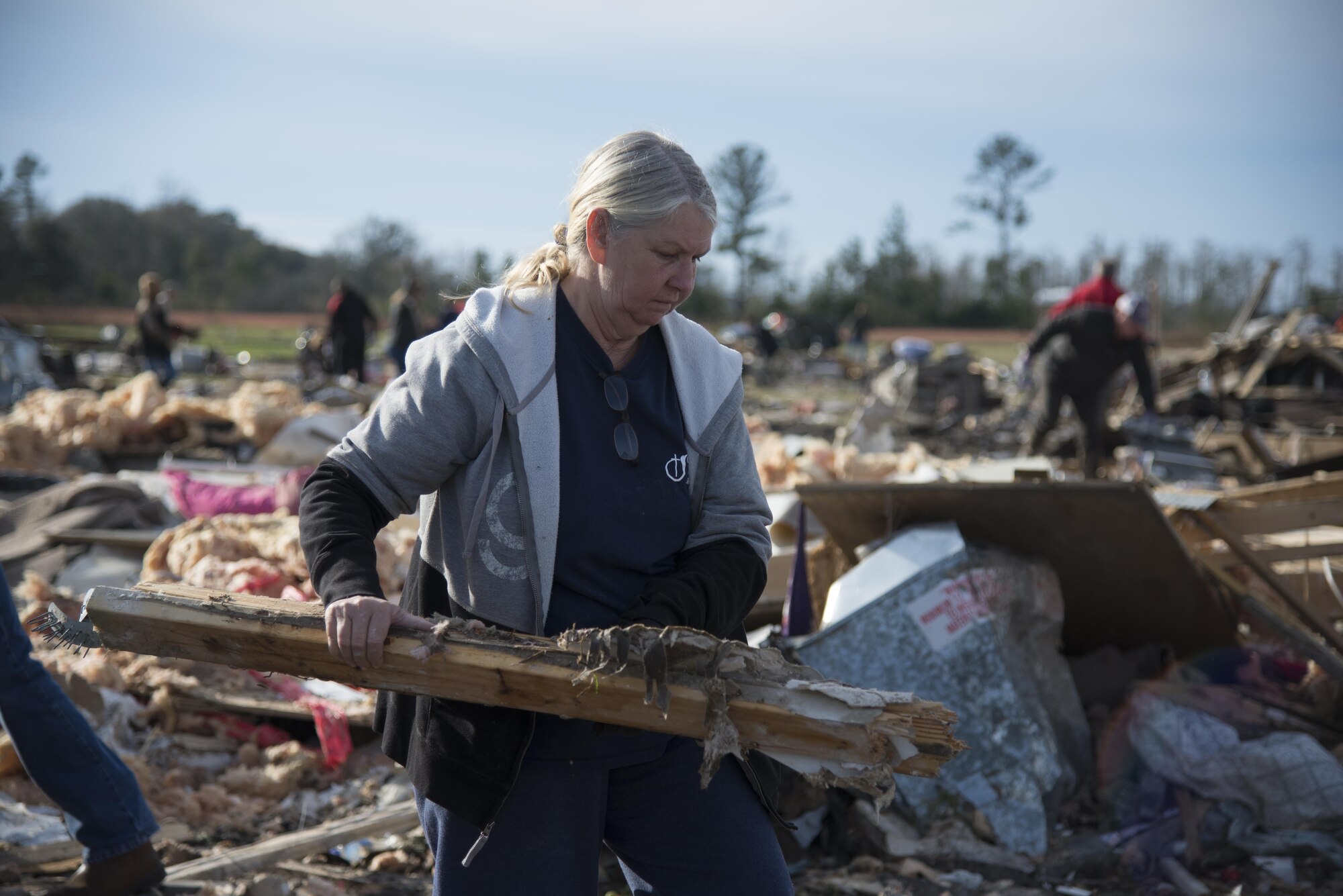 A volunteer carries salvageable wood to a pile, Jan. 28, 2017, in Adel, Ga. The wood was salvaged to later rebuild the neighborhood that was destroyed by the same tornado that killed 15 people and was later deemed an EF3, the strongest tornado to touch down in the county’s history. (U.S. Air Force photo by 2d Lt. Kaitlin Toner)