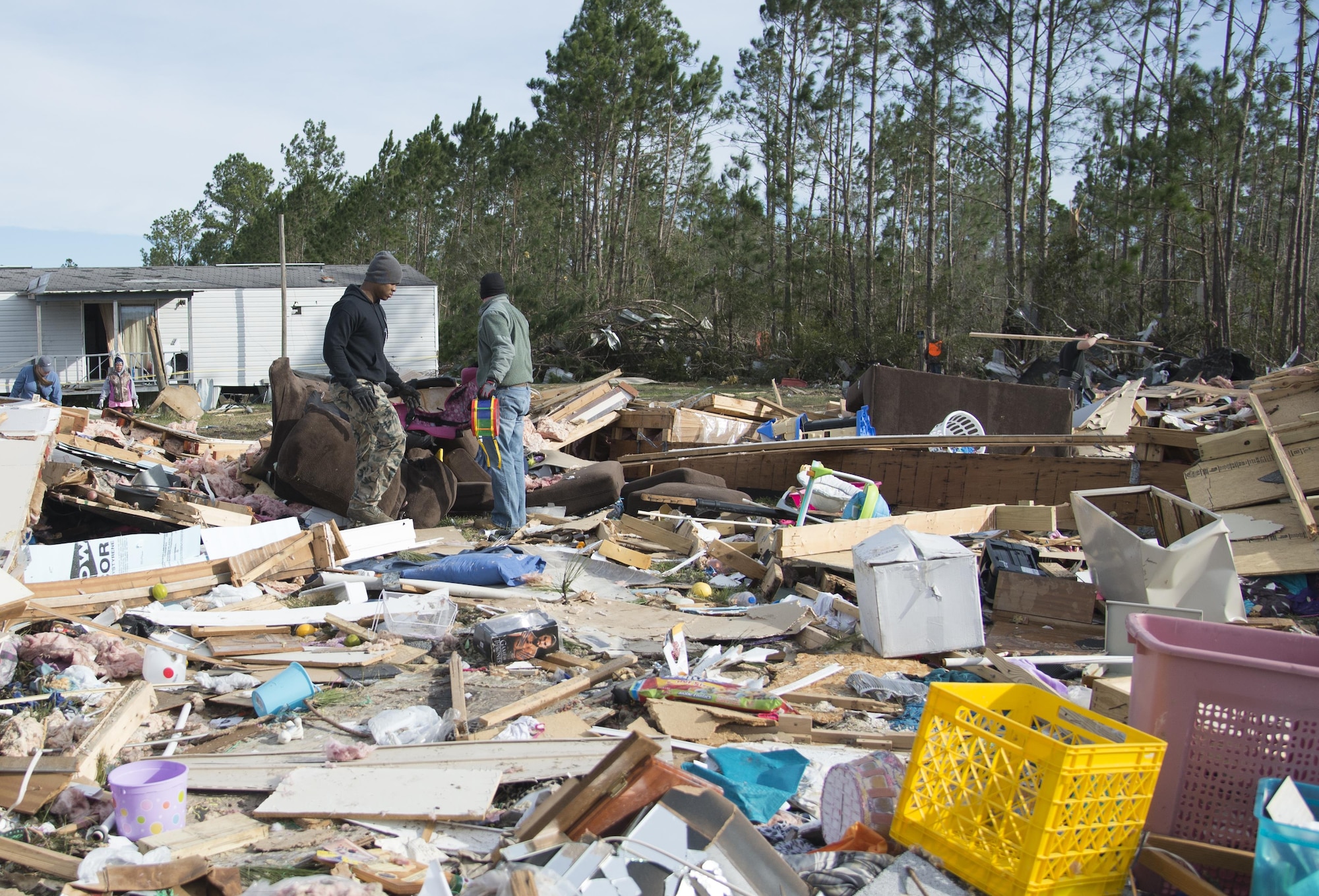 Two Moody Air Force Base Airmen search for meaningful belongings amongst debris left in the wake of a tornado, Jan. 28, 2017, in Adel, Ga. The tornado killed 15 people and was later deemed an EF3, the strongest tornado to touch down in the county’s history. (U.S. Air Force photo by 2d Lt. Kaitlin Toner)