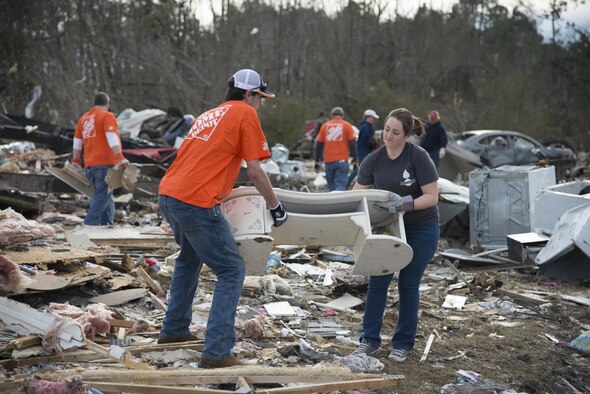 A Moody Air Force Base Airman and another volunteer team up to carry salvageable furniture out of the debris left in the wake of a tornado, Jan. 28, 2017, in Adel, Ga. The tornado killed 15 people and was later deemed an EF3, the strongest tornado to touch down in the county’s history. (U.S. Air Force photo by 2d Lt. Kaitlin Toner)