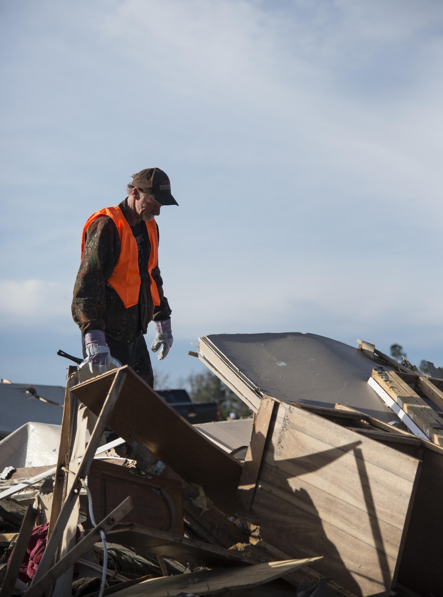 A volunteer stands on top of a pile of debris left in the wake of a tornado, Jan. 28, 2017, in Adel, Ga. The tornado killed 15 people and was later deemed an EF3, the strongest tornado to touch down in the county’s history. (U.S. Air Force photo by 2d Lt. Kaitlin Toner)