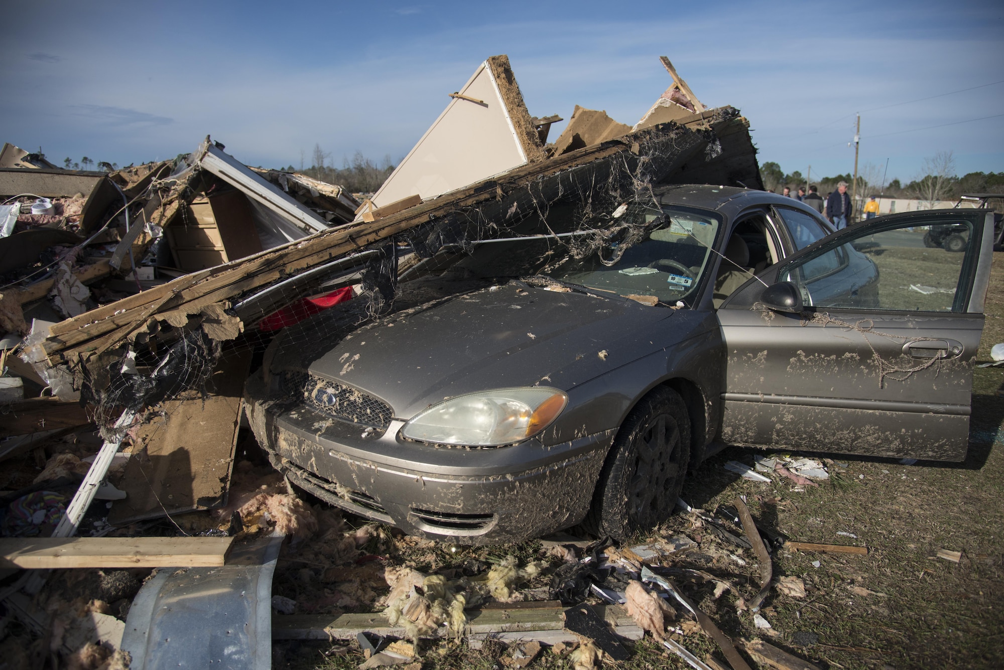 A car lays beneath part of a home that was destroyed by a deadly tornado, Jan. 28, 2017, in Adel, Ga. The tornado killed 15 people and was later deemed an EF3, the strongest tornado to touch down in the county’s history. (U.S. Air Force photo by 2d Lt. Kaitlin Toner)