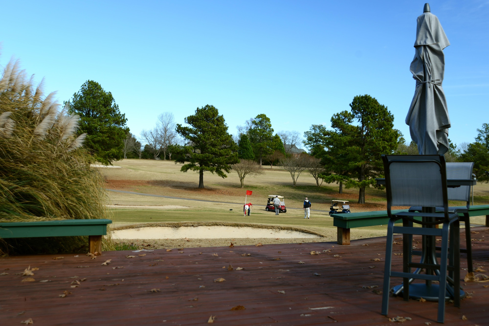 Team Shaw members play golf at the 18th hole near the patio at the Carolina Lakes Golf Course at Shaw Air Force Base, S.C., Jan. 26, 2017. New outdoor furniture was added to the patio of the Stephen M. Creech Golf Complex as part of the golf course’s renovations, which were completed Jan. 15. (U.S. Air Force photo by Airman 1st Class Kathryn R.C. Reaves)