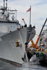 In this file photo,Sailors aboard the Ticonderoga-class guided missile cruiser USS Shiloh (CG 67) us a firehose to clean the ships anchor as they prepare to depart Fleet Activities (FLEACT) Yokosuka to continue their 2016 patrol. FLEACT Yokosuka provides, maintains, and operates base facilities and services in support of U.S. 7th Fleet’s forward-deployed naval forces, 83 tenant commands, and 24,000 military and civilian personnel.