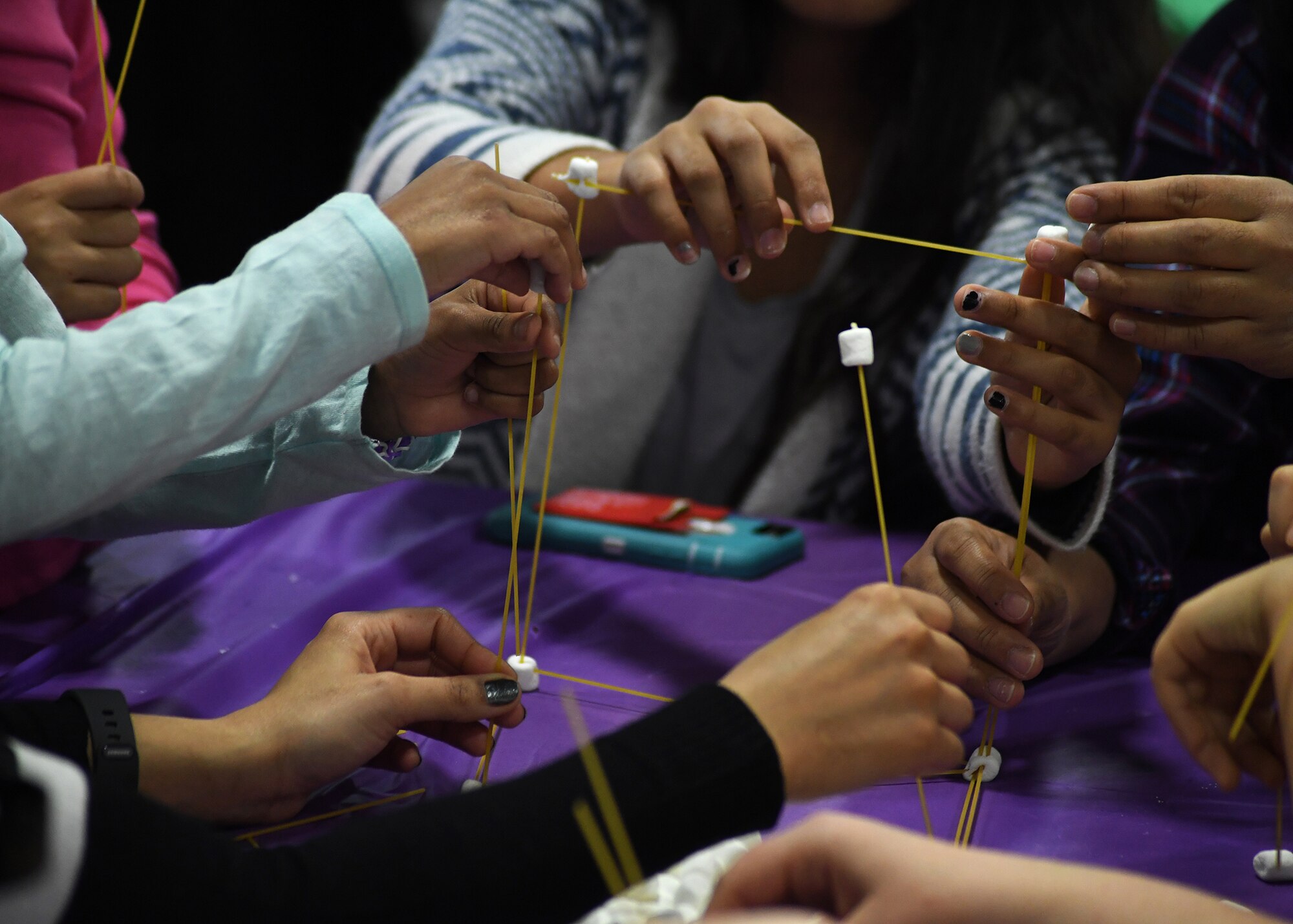 Grand Forks Air Force Base youth work together to build a structure out of marshmallows and spaghetti Jan. 28, 2017, on Grand Forks AFB, N.D. Mothers and daughters attended a Science, Technology, Engineering and Math event and participated in a variety of engineering based activities. (U.S. Air Force photo by Senior Airman Sparks)