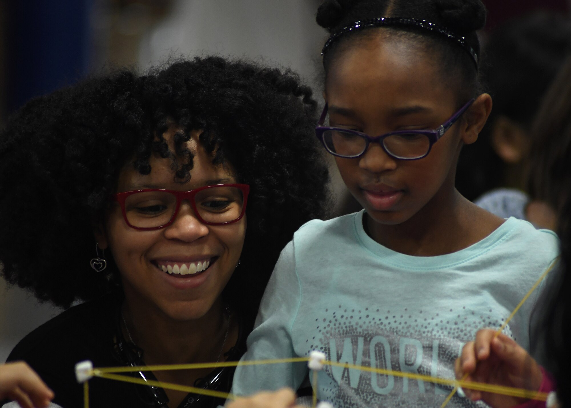 Seimorne Johnson and her daughter Serenity, 7, work together at a Science, Technology, Engineering and Math event Jan. 28, 2017, on Grand Forks Air Force Base, N.D. Mother and daughters were able to spend time together completing a variety of activities in the STEM field. (U.S. Air Force photo by Senior Airman Sparks)