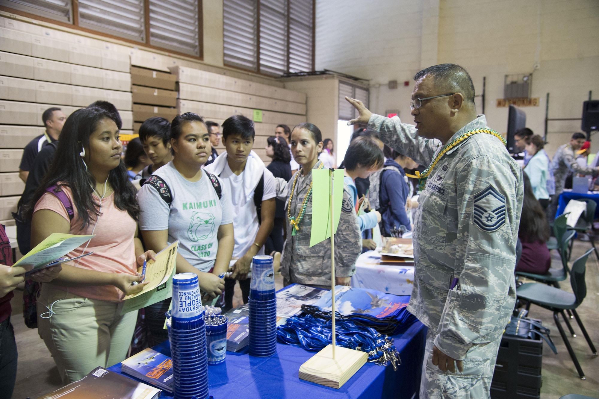 U.S. Air Force Senior Master Sgt. Peter Rieta, 48th Aerial Port Squadron, talks with students during a career fair at Kaimuki High School, Honolulu, Hawaii, Jan 27, 2017. Eleven Airmen from the 624th Regional Support Group volunteered alongside the local recruiting station in support of the fair, which provided career guidance to more than 800 Hawaii students. Located on Oahu and Guam, and a component of the Air Force Reserve, the 624th Regional Support Group's mission is to deliver mission essential capability through combat readiness, quality management and peacetime deployments in the Pacific area of responsibility. (U.S. Air Force photo by Master Sgt. Theanne Herrmann) 