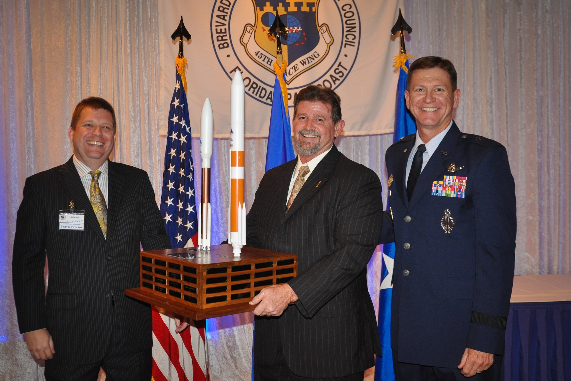 Travis Proctor, CivMil Chairman of the Board, left, and Brig. Gen. Wayne Monteith, 45th Space Wing commander, right, present John Baker, senior project manager for Millennium Engineering & Integration Company, with the CivMil Member of the Year Award Jan. 21, 2017, at Patrick Air Force Base, Fla. Baker was selected as CivMil Member of the Year for his selfless donation of time and leadership in securing volunteers to ensure successful community events. (U.S. Air Force photo by 1st Lt. Amanda Herman)