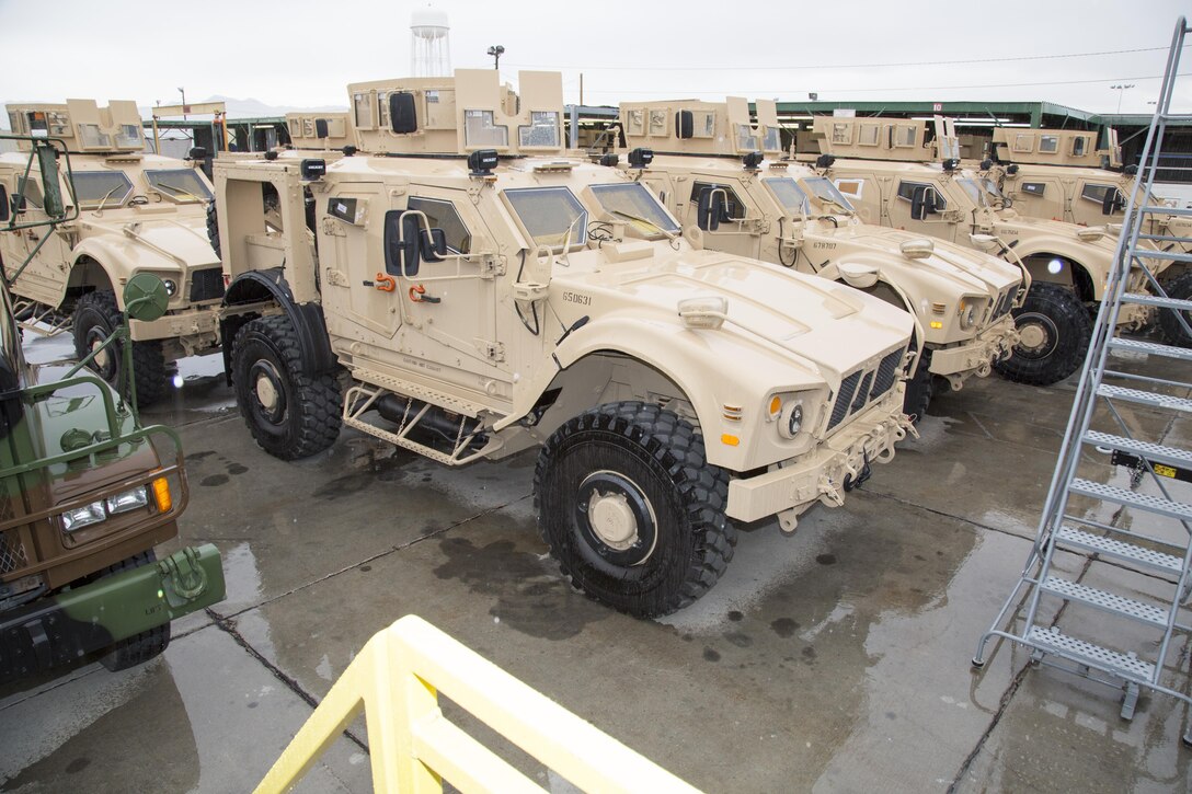 On a rare rainy Mojave Desert day, Mine Resistant Ambush Protected All Terrain Vehicles, or M-ATV, have finished their upgrades and armor improvements and await road testing at Production Plant Barstow, Marine Depot Maintenance Command, on the Yermo Annex of Marine Corps Logistics Base Barstow, Jan. 12. The specialized vehicles are favored for troop transporting in the mountainous country of Afghanistan. The turret atop the M-ATV mark this as a Marine Corps variant of the MRAP.
