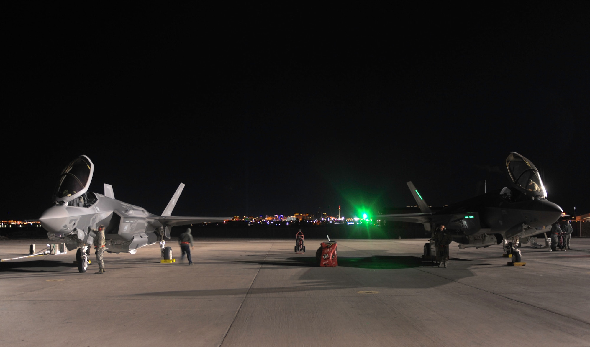 Maintainers assigned to the 419th and 388th Fighter Wings, Hill Air Force Base, Utah, prepare two F-35A Lightning II aircraft to participate in Red Flag 17-1 night operations on Nellis Air Force Base, Nev., Jan. 24, 2017. Night missions have been integrated into Red Flag to prepare aircrews for missions in low-light environments. (U.S. Air Force photo by Airman 1st Class Kevin Tanenbaum/Released) 
