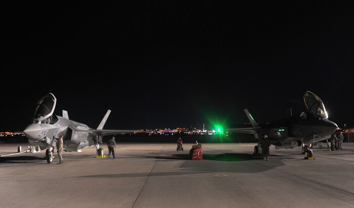 Maintainers assigned to the 419th and 388th Fighter Wings, Hill Air Force Base, Utah, prepare two F-35A Lightning II aircraft to participate in Red Flag 17-1 night operations on Nellis Air Force Base, Nev., Jan. 24, 2017. Night missions have been integrated into Red Flag to prepare aircrews for missions in low-light environments. (U.S. Air Force photo by Airman 1st Class Kevin Tanenbaum/Released) 
