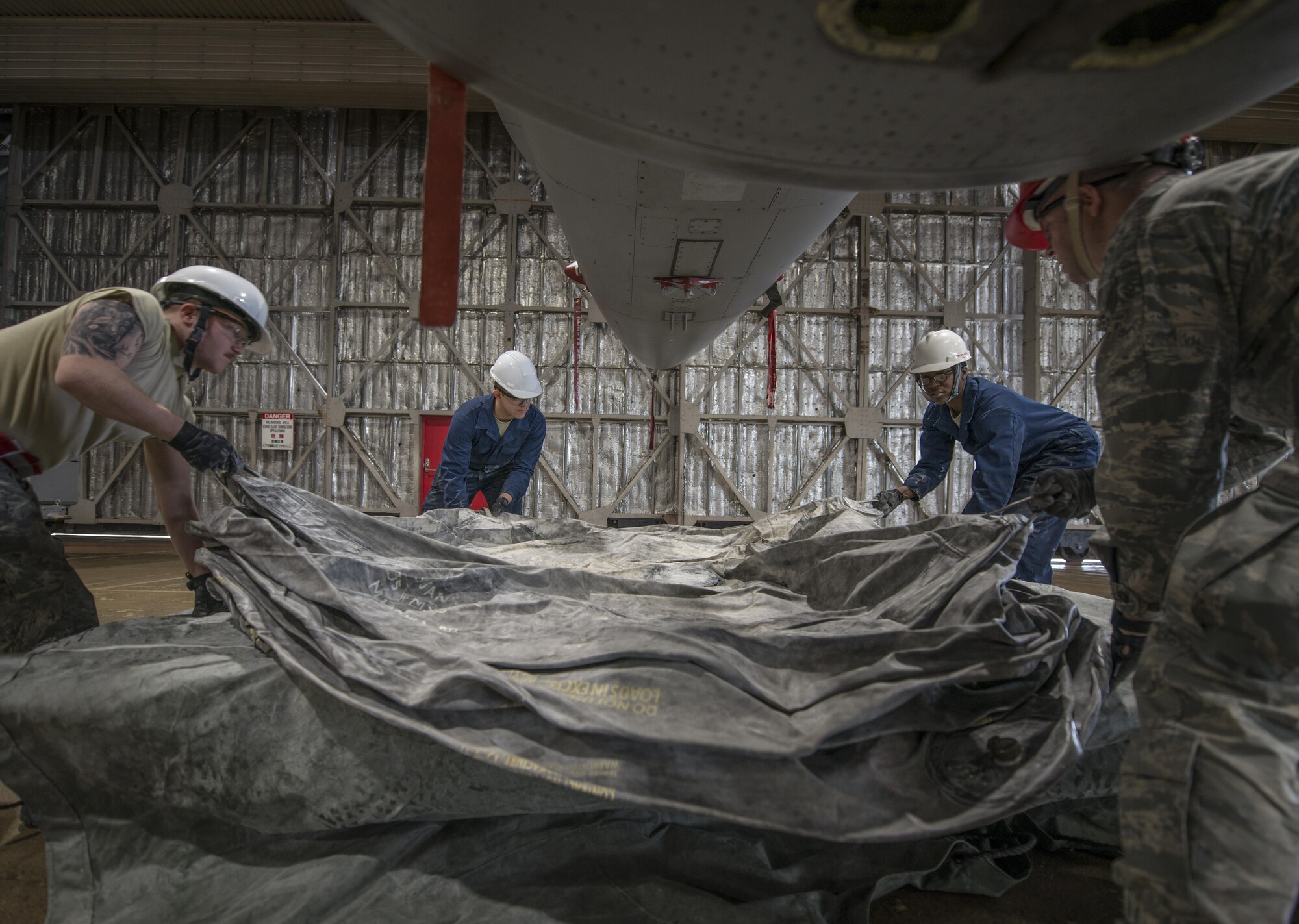 Airmen with the 35th Maintenance Squadron crashed, damaged, disabled aircraft recovery unit center a lifting bag on a pallet build up at Misawa Air Base, Japan, Jan. 28, 2017. These Airmen respond to aircraft incidents when an aircraft needs to be lifted to retract landing gear or moved off an active runway, enabling normal mission operations to resume. (U.S. Air Force photo by Senior Airman Brittany A. Chase)