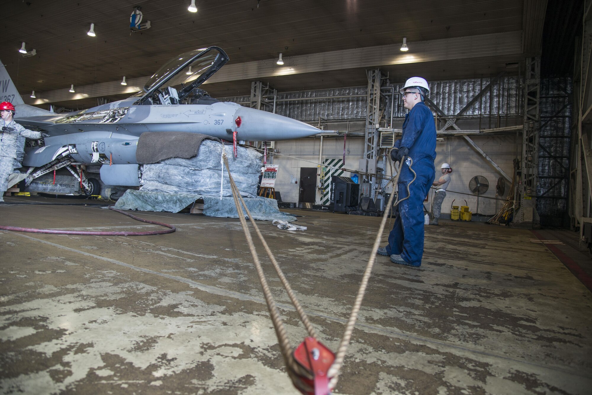 Airmen with the 35th Maintenance Squadron crashed, damaged, disabled aircraft recovery unit stabilize an F-16 Fighting Falcon at Misawa Air Base, Japan, Jan. 28, 2017. Airmen assigned to the unit participate in annual CDDAR training, giving them scenarios to hone their skill in case of a real-world incident. (U.S. Air Force photo by Senior Airman Brittany A. Chase)