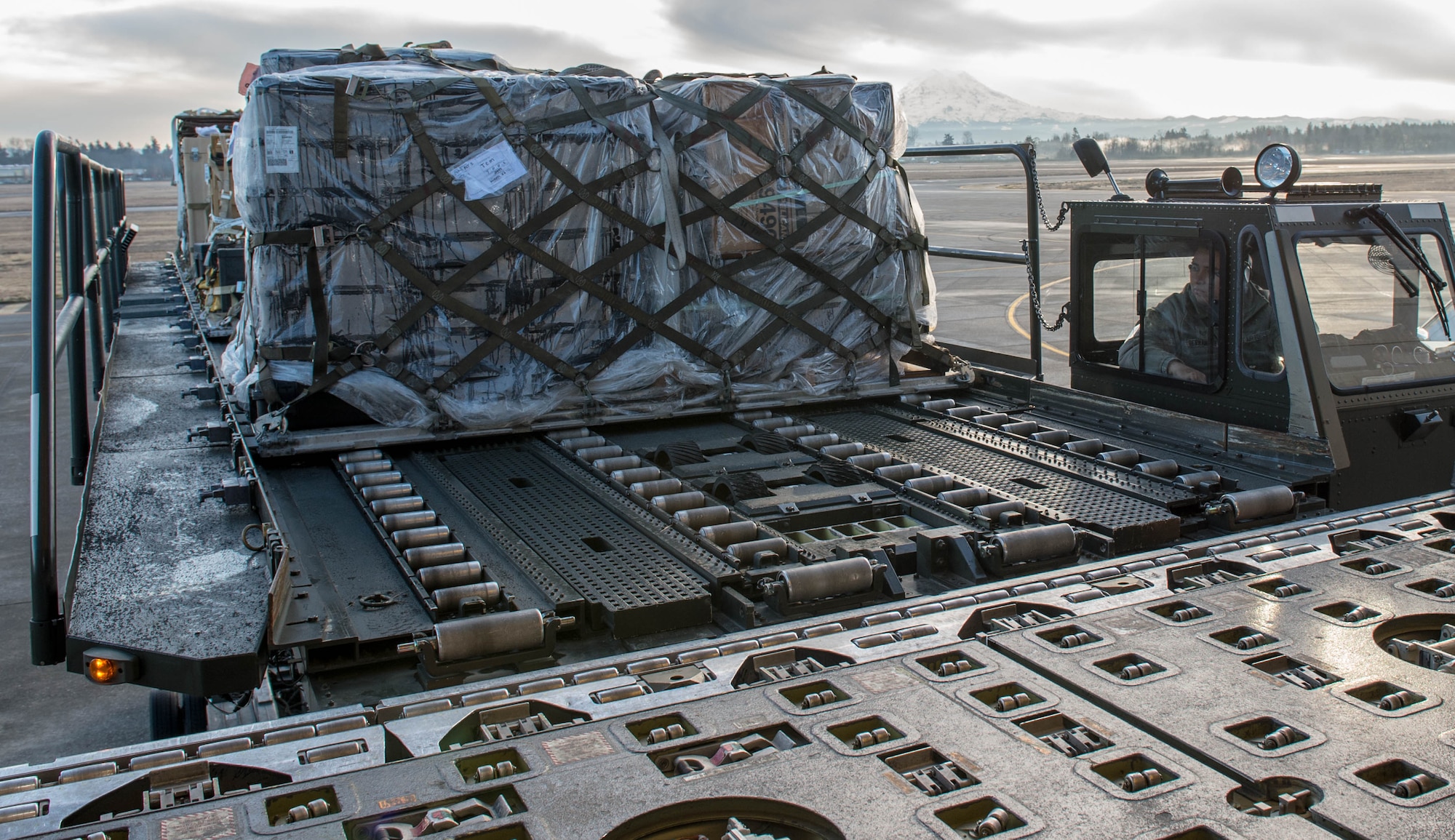 Staff Sgt. Jorge Hernandez, 821st Contingency Response Squadron, uses a K-loader to load cargo onto a KC-10 Extender aircraft from Travis Air Force Base, Calif., Jan. 23, 2017, at Joint Base Lewis-McChord, Washington. Airmen from the 821st Contingency Response Group, exercised their capability to support humanitarian efforts during exercise Dragon Breath at JBLM and Fairchild Air Force Base. (U.S. Air Force photo by Staff Sgt. Robert Hicks)
