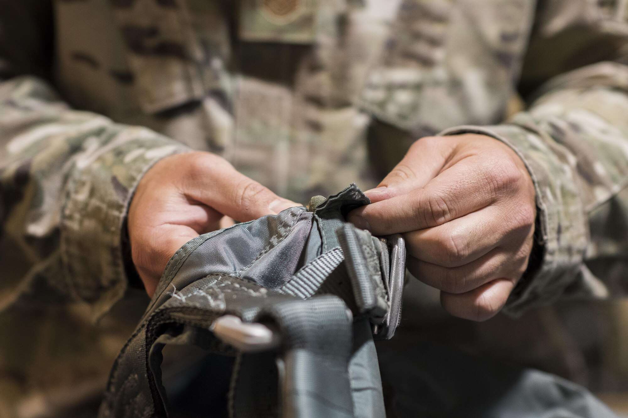Tech. Sgt. Todd Huerta, 332nd Aircrew Flight Equipment non-commissioned officer in charge, inspects a harness June 12, 2017, in Southwest Asia. With the amount of hours spent flying, a pilot’s equipment is susceptible to wear and tear and must be routinely inspected. (U.S. Air Force photo/Senior Airman Damon Kasberg)