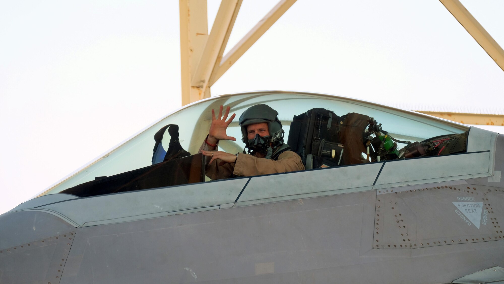 Brig. Gen. Charles S. Corcoran, 380th Air Expeditionary Wing commander, waves to Airmen of the 380 AEW at his fini-flight June 30, 2017, at an undisclosed location in southwest Asia. Corcoran is an experienced command pilot with more than 3,000 flying hours. (U.S. Air Force photo by Senior Airman Preston Webb)