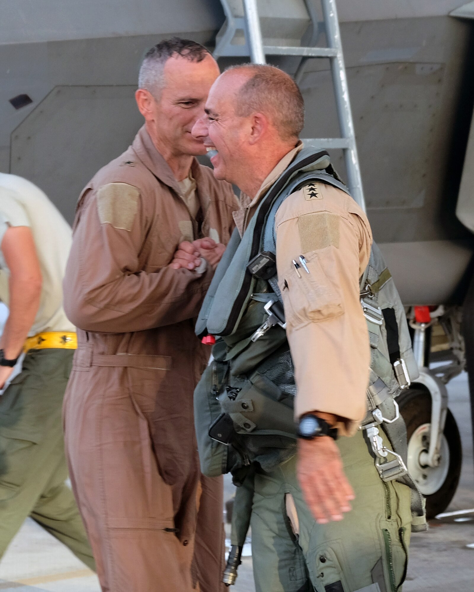 Brig. Gen. Charles S. Corcoran, left, 380th Air Expeditionary Wing commander, shares a word with Lt. Gen. Jeffrey L. Harrigian, U.S. Air Forces Central Command commander, at his fini-flight June 30, 2017, at an undisclosed location in southwest Asia. Harrigian, a captain at the time, previously served as an instructor to then 2nd Lt. Charles Corcoran. (U.S. Air Force photo by Senior Airman Preston Webb)