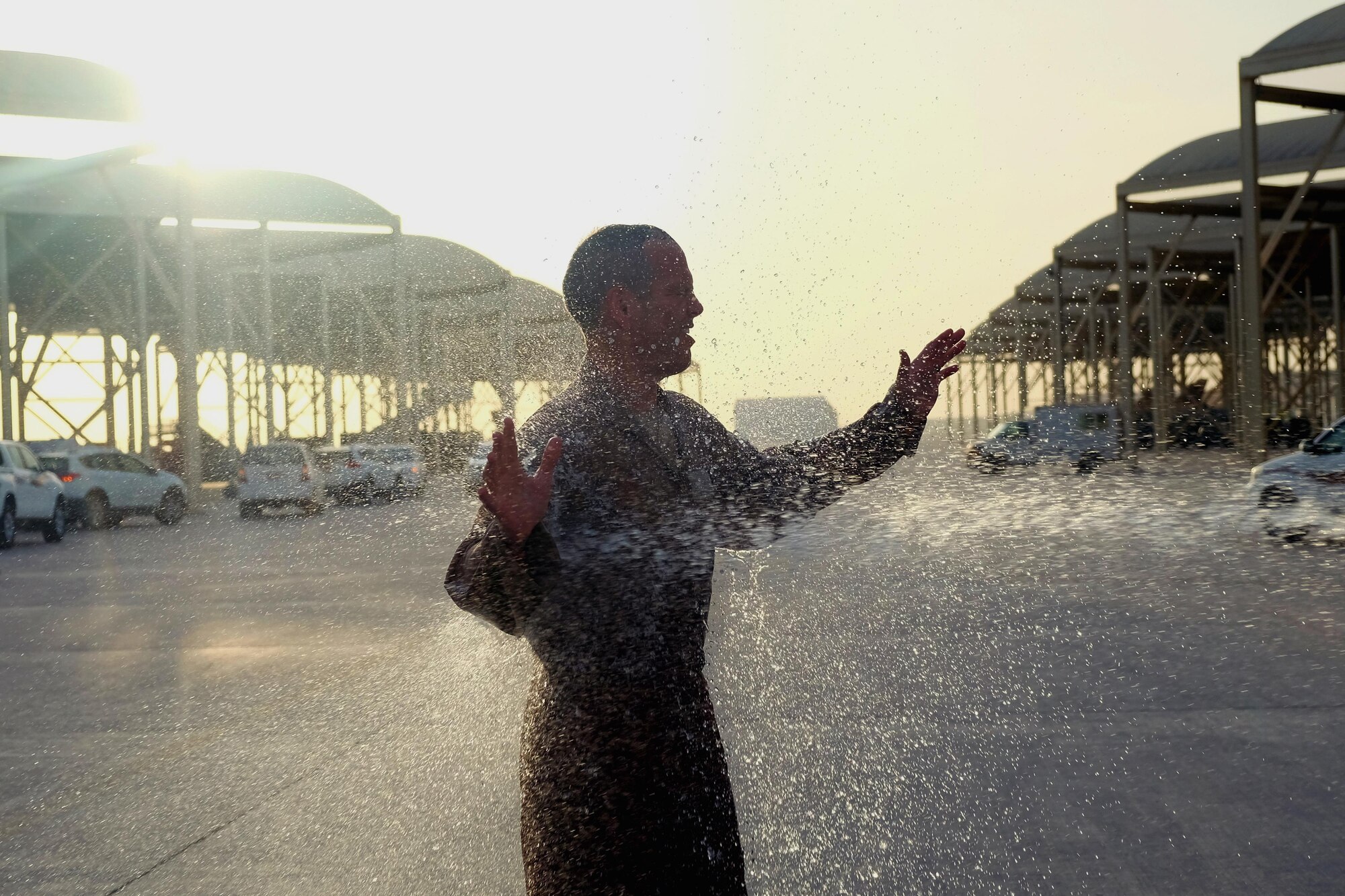 Brig. Gen. Charles S. Corcoran, 380th Air Expeditionary Wing commander, gets sprayed with water at his fini-flight June 30, 2017, at an undisclosed location in southwest Asia. Members of the 380th Expeditionary Civil Engineer Squadron Fire Department sprayed the general with a fire hose. (U.S. Air Force photo by Senior Airman Preston Webb)