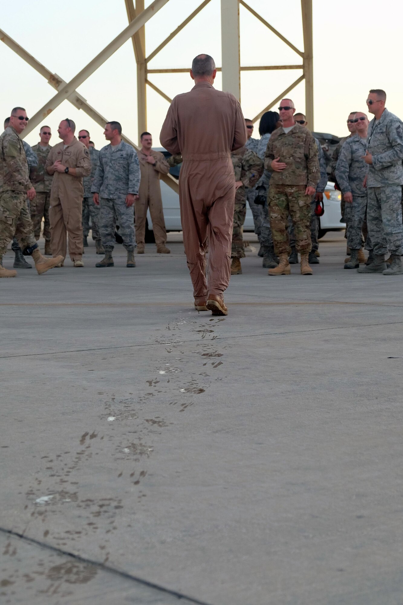 Brig. Gen. Charles S. Corcoran, 380th Air Expeditionary Wing commander, walks to greet Airmen of the 380 AEW at his fini-flight June 30, 2017, at an undisclosed location in southwest Asia. Before departing, Corcoran greeted every Airman in attendance to thank them for their service. (U.S. Air Force photo by Senior Airman Preston Webb)