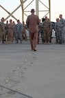 Brig. Gen. Charles S. Corcoran, 380th Air Expeditionary Wing commander, walks to greet Airmen of the 380 AEW at his fini-flight June 30, 2017, at an undisclosed location in southwest Asia. Before departing, Corcoran greeted every Airman in attendance to thank them for their service. (U.S. Air Force photo by Senior Airman Preston Webb)