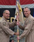 From right, Brig. Gen. Derek C. France, incoming 380th Air Expeditionary commander, receives the 380 AEW guidon from Lt. Gen. Jeffrey L. Harrigian, U.S. Air Forces Central Command commander, during a change of command ceremony July 1, 2017, at an undisclosed location in southwest Asia. The passing of the guidon signifies transfer of authority from one commander to the next. (U.S. Air Force photo by Senior Airman Preston Webb)