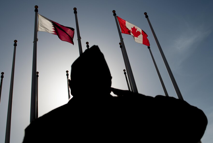 A Canadian service member salutes the Canadian flag during a flag raising ceremony in honor of Canada Day, July 1, 2017, at Al Udeid Air Base, Qatar. Canada Day commemorates the anniversary of the July 1, 1867, enactment of the British North America Act, also referred to as the Constitution Act of 1867. Canada is at the forefront of international efforts to counter ISIS, as part of Combined Joint Task Force – Operation Inherent Resolve, the global Coalition to defeat ISIS in Iraq and Syria. (U.S. Air Force photo by Staff Sgt. Alexander W. Riedel)