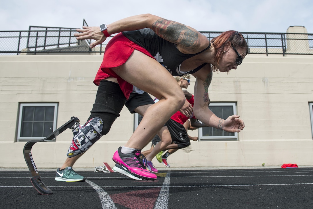 Marine Corps veteran Sarah Rudder teaches starting from the blocks during track practice for the 2017 Department of Defense Warrior Games in Chicago, June 30, 2017. Rudder is an ambassador for the games. DoD photo by EJ Hersom